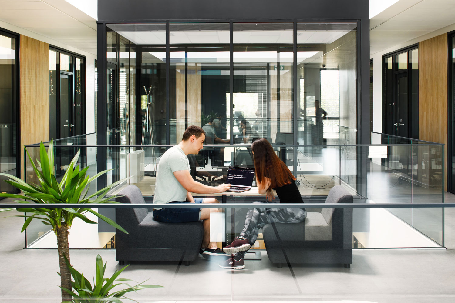 Two people talking on the hallway about development
