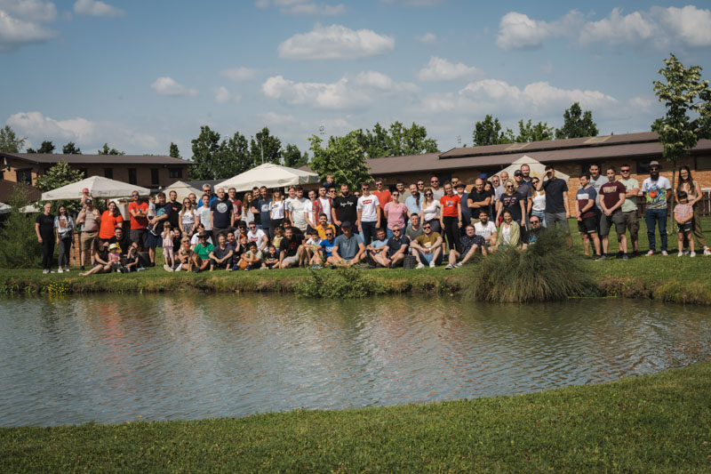 Mono team group photo by the lake at a company outing