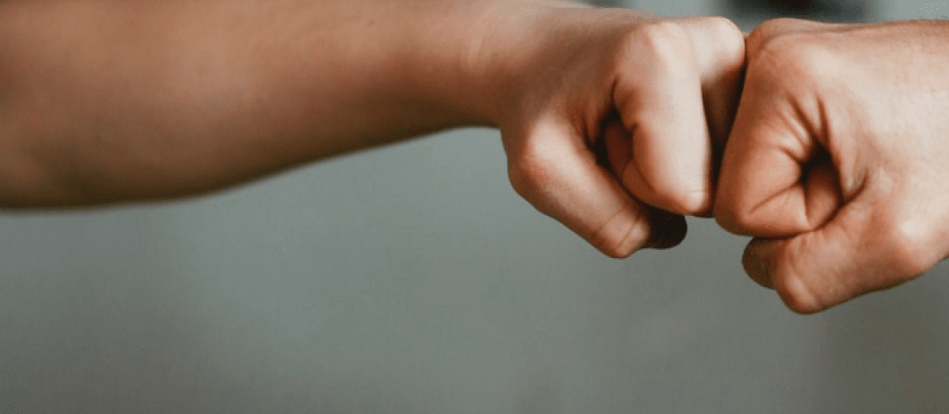Two fists bumping